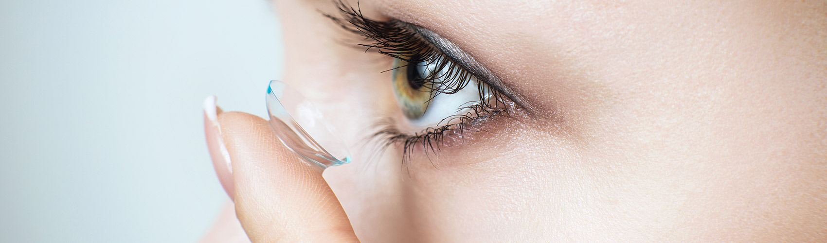 woman inserting contact lens